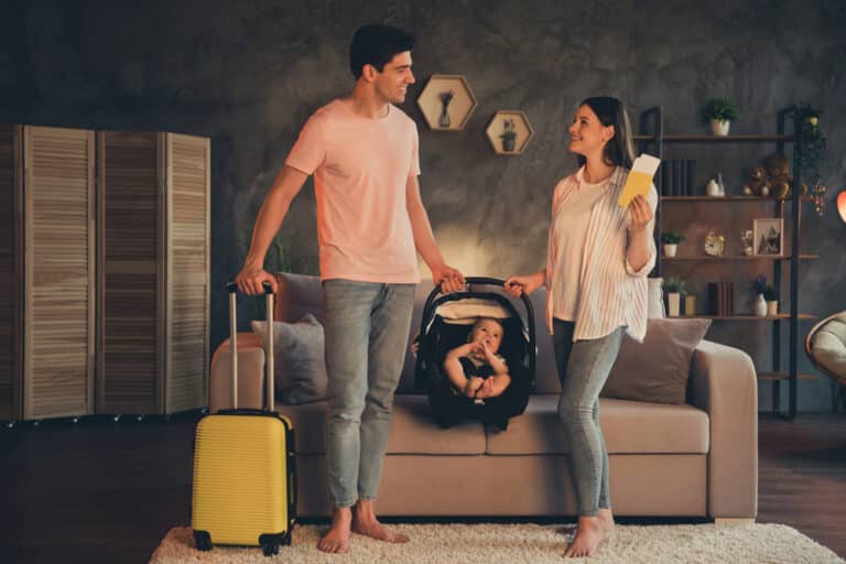 Parent securing a baby safely in a car seat inside a vehicle