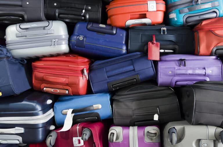 Family with heavy suitcases and luggage at an airport terminal